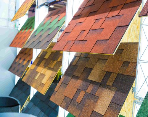 Asphalt Shingles: How To Select The Perfect Color 2'x2' shingle samples neatly displayed in showroom