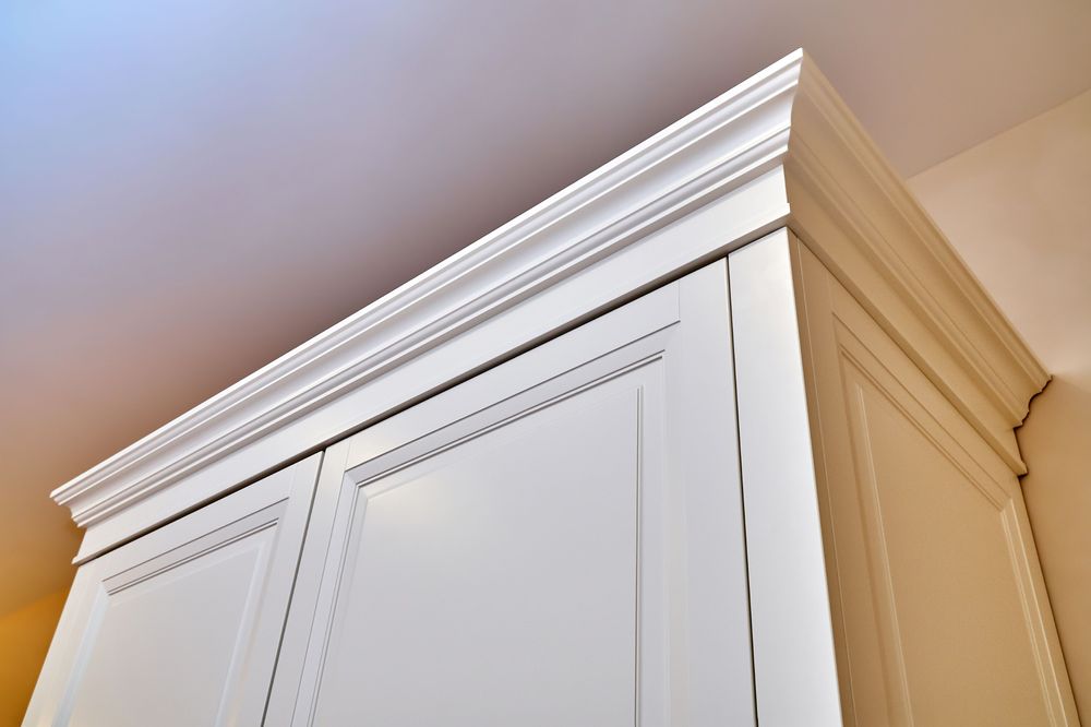upward angle showing white crown moulding on white cabinet