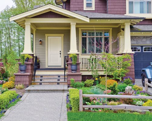 Enhancing Curb Appeal By Updating Your Doors Well-Manicured Front Lawn of Home With Pale Yellow Front Door