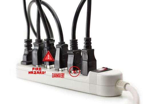 10 Tips Power Strip and Extension Cord Safety white power strip with a black extension cord plugged into each outlet