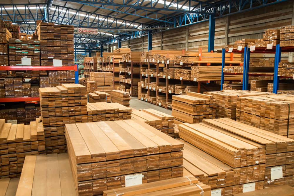 Warehouse Packed With Various Sizes of Lumber Neatly Stacked On Shelving Units. 